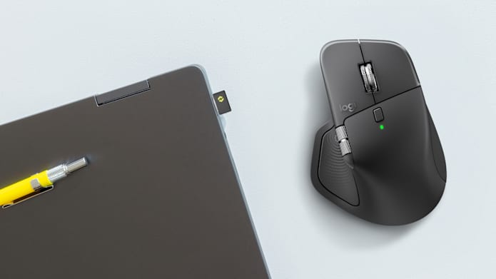 Logitech MX Master 4 mouse with Logi Bolt USB-C receiver connected to laptop